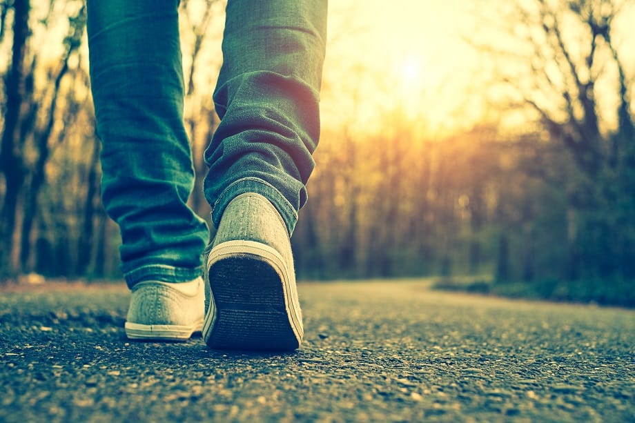 Student walking on paved road